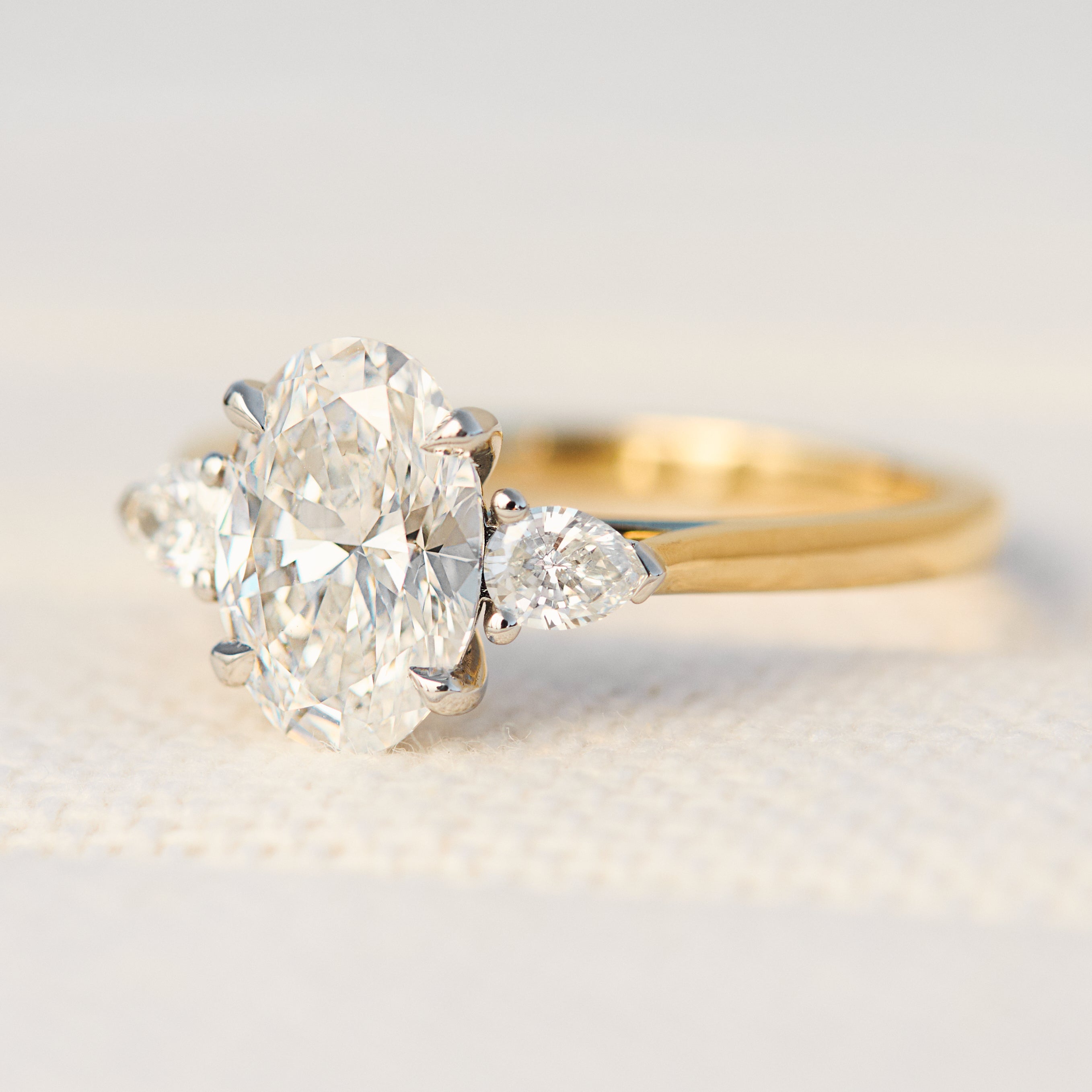 oval lab grown diamond yellow gold and platinum engagement ring