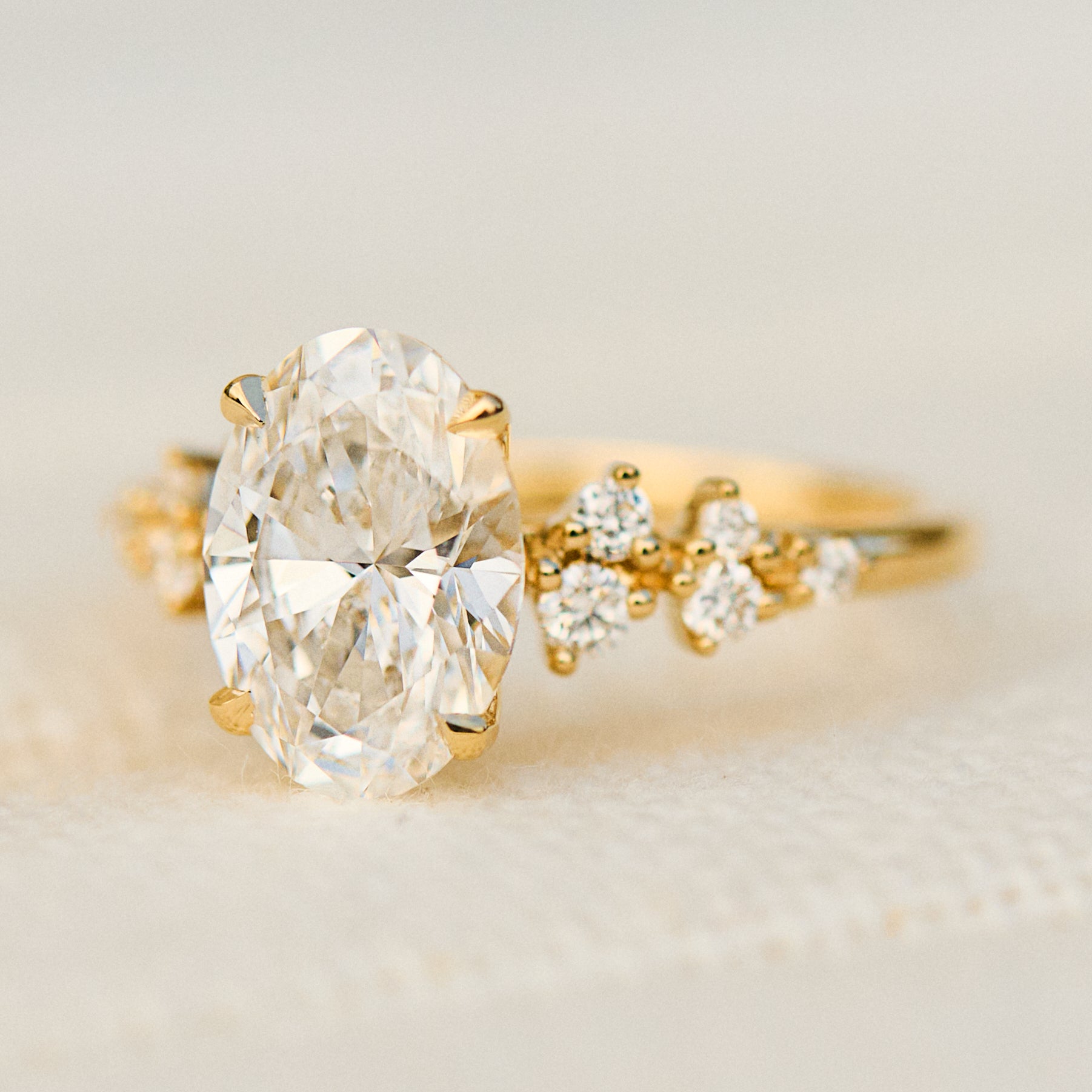 oval lab grown diamond yellow gold engagement cluster ring