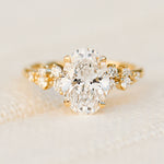 oval lab grown diamond yellow gold engagement cluster ring