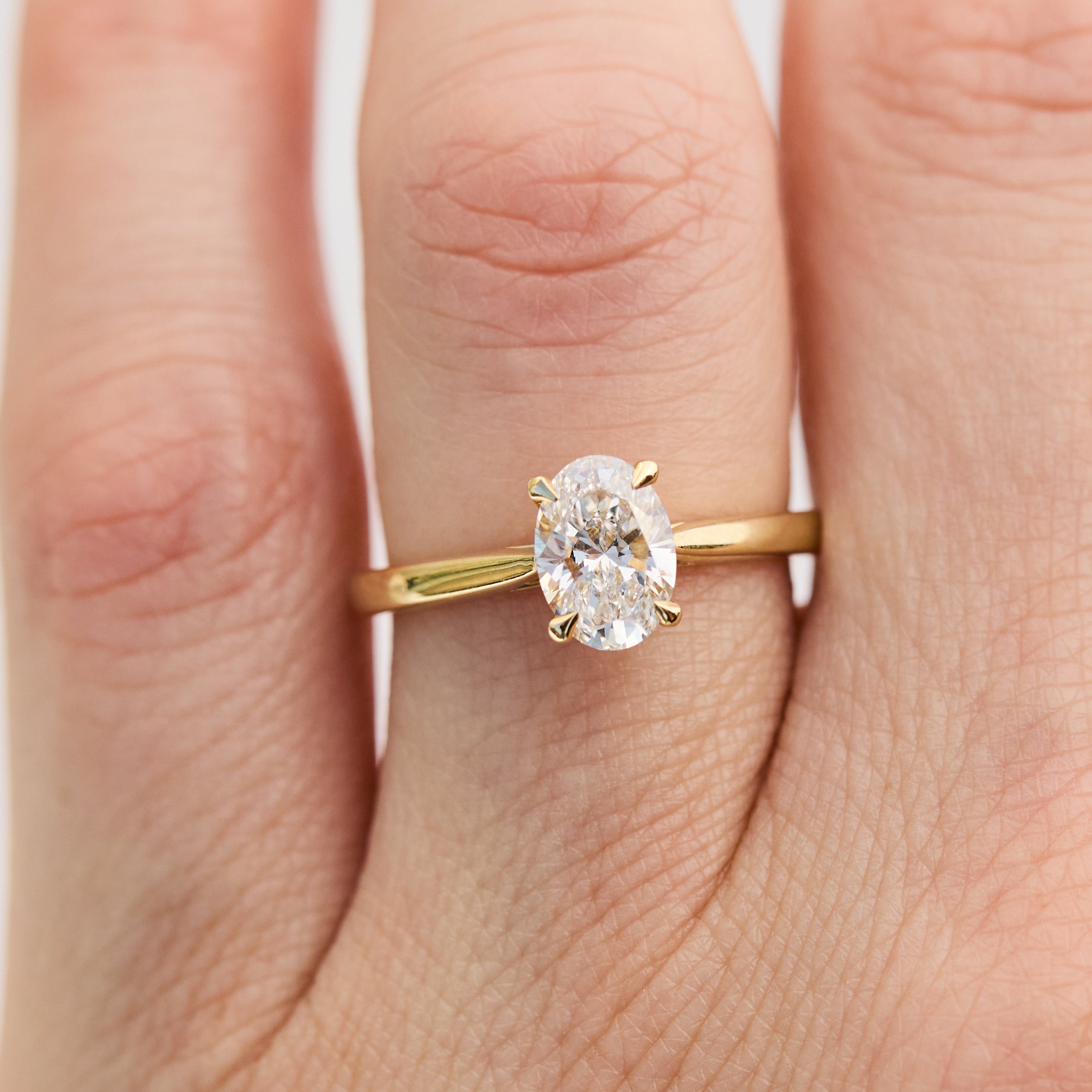 oval lab grown diamond yellow gold engagement ring