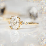 cushion cut moissanite and diamond engagement ring in yellow gold
