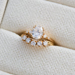 cushion cut moissanite and diamond engagement ring in yellow gold