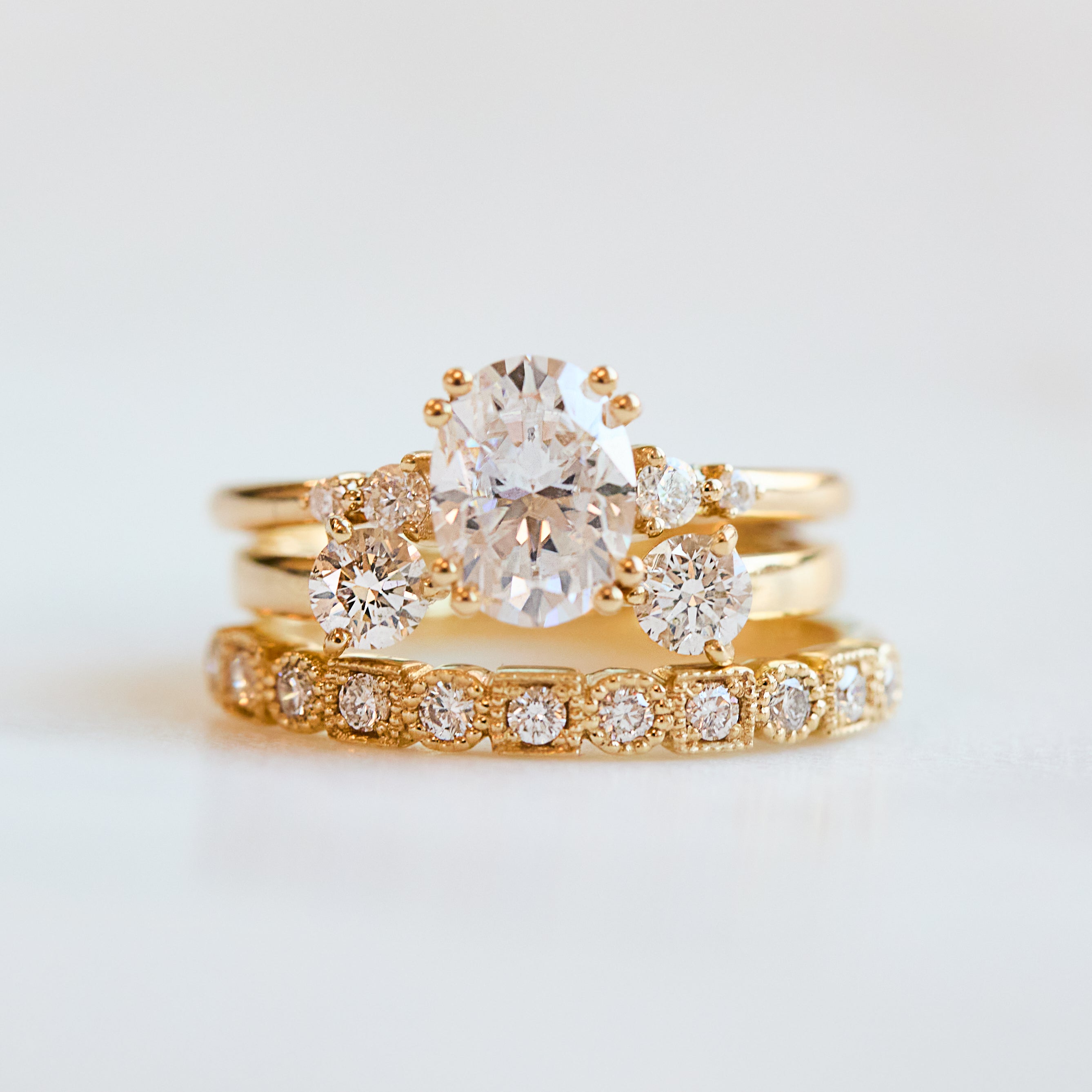 cushion cut moissanite and diamond engagement ring in yellow gold