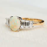 oval opal and diamond engagement ring set in yellow gold and platinum
