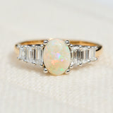 oval opal and diamond engagement ring set in yellow gold and platinum