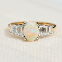 oval opal and diamond engagement ring set in yellow gold and platinum
