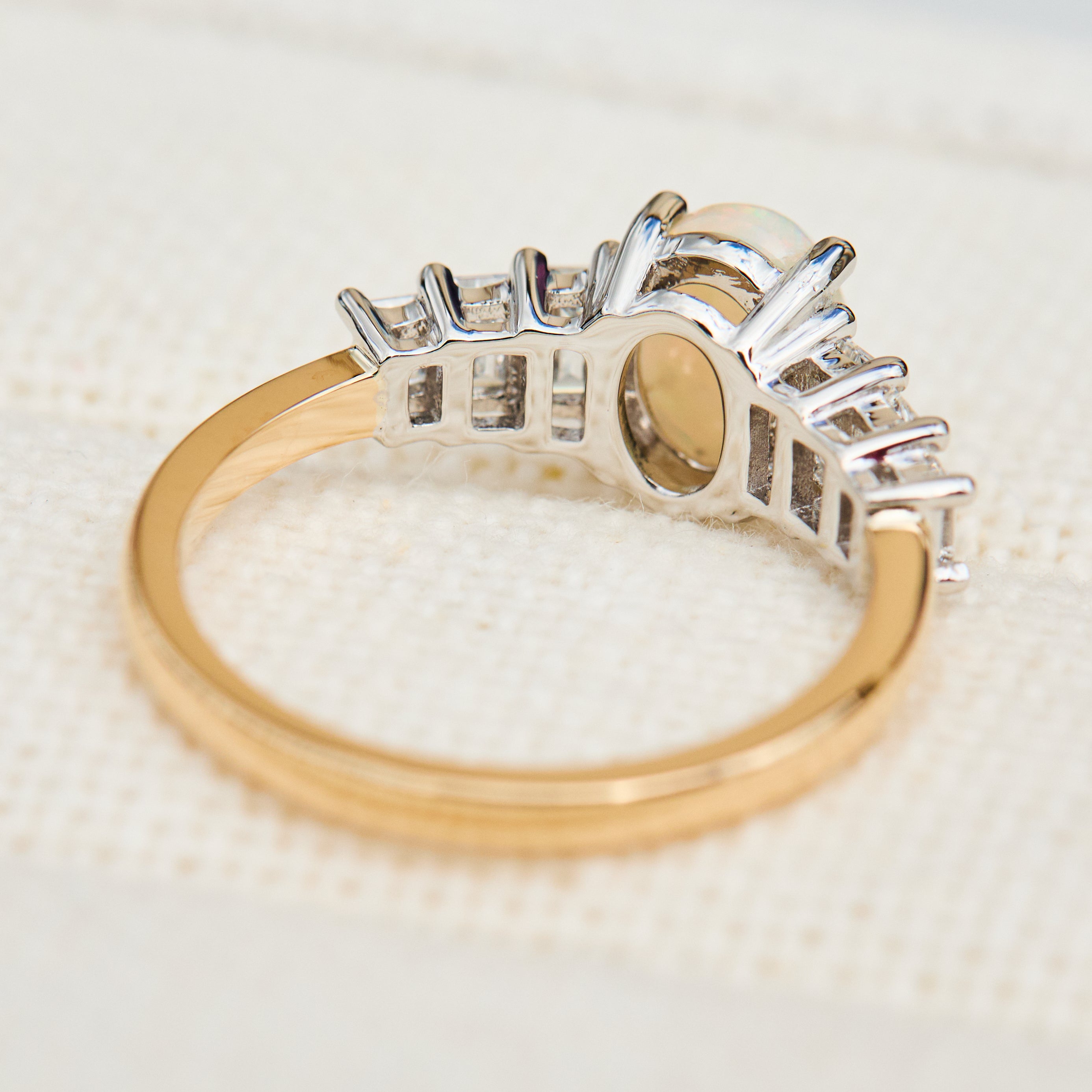 oval opal and diamond engagement ring set in yellow gold and platinum
