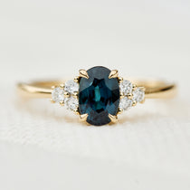 oval teal sapphire yellow gold engagement ring