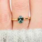oval teal sapphire solitaire engagement ring in yellow gold