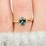 oval teal sapphire solitaire engagement ring in yellow gold
