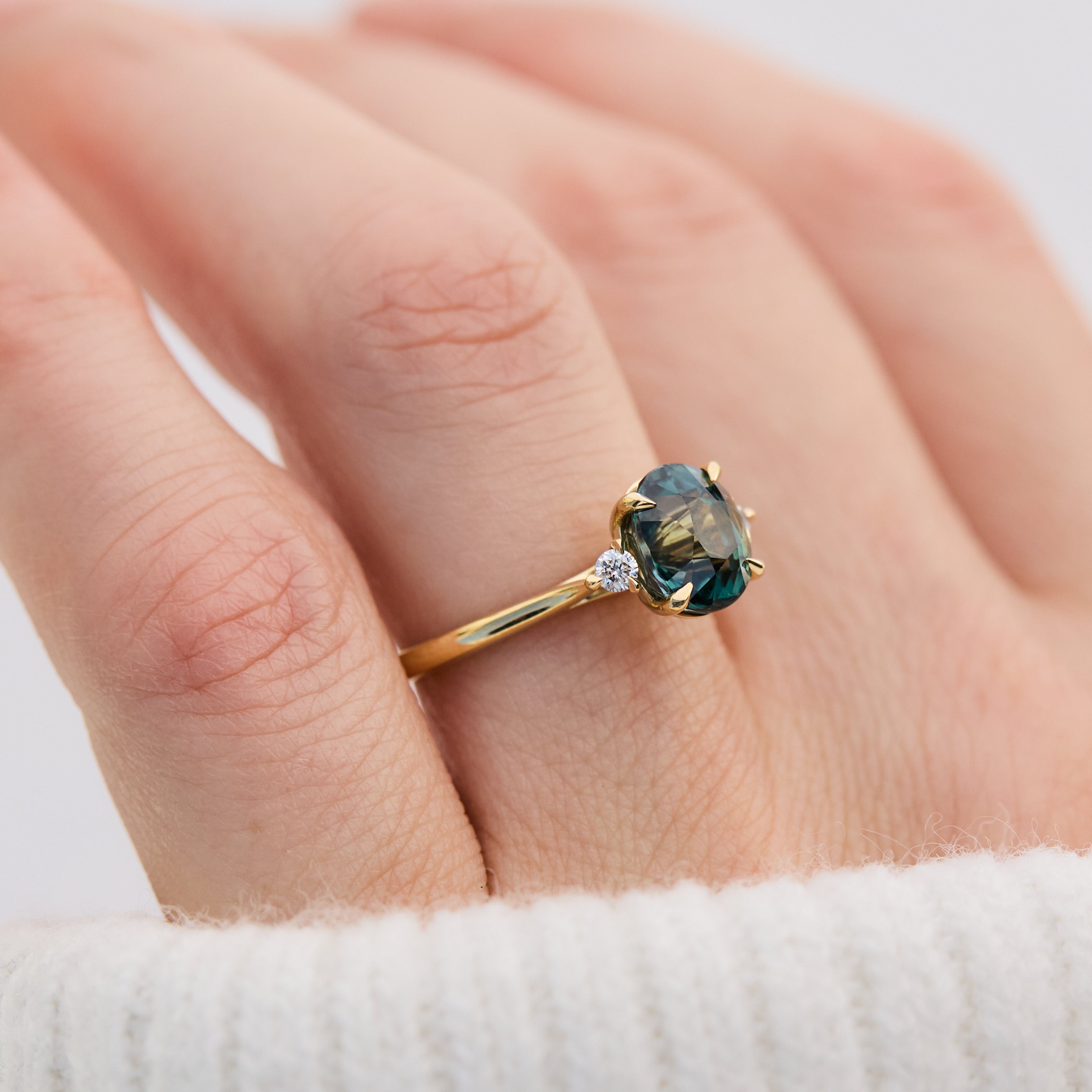 oval sapphire trilogy engagement ring in yellow gold