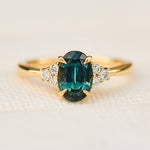 oval teal green sapphire and diamonds yellow gold engagement ring