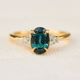 oval teal green sapphire and diamonds yellow gold engagement ring