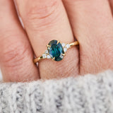 oval teal green sapphire and diamonds yellow gold engagement ring