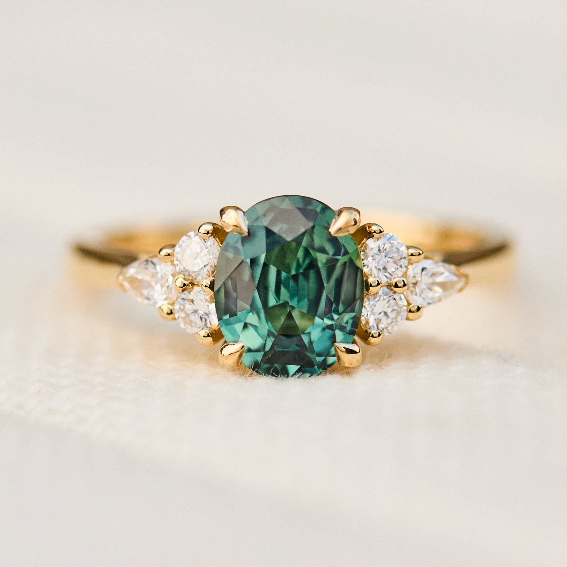 oval teal sapphire and diamonds yellow gold engagement ring