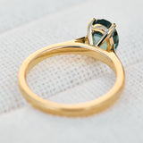 oval teal sapphire solitaire engagement ring in yellow gold