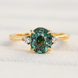 oval teal sapphire yellow gold engagement ring