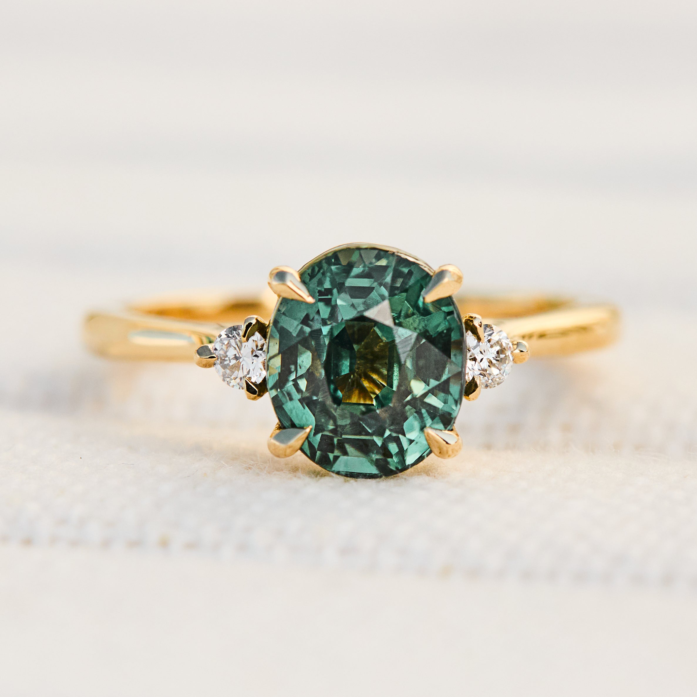 oval teal sapphire yellow gold engagement ring