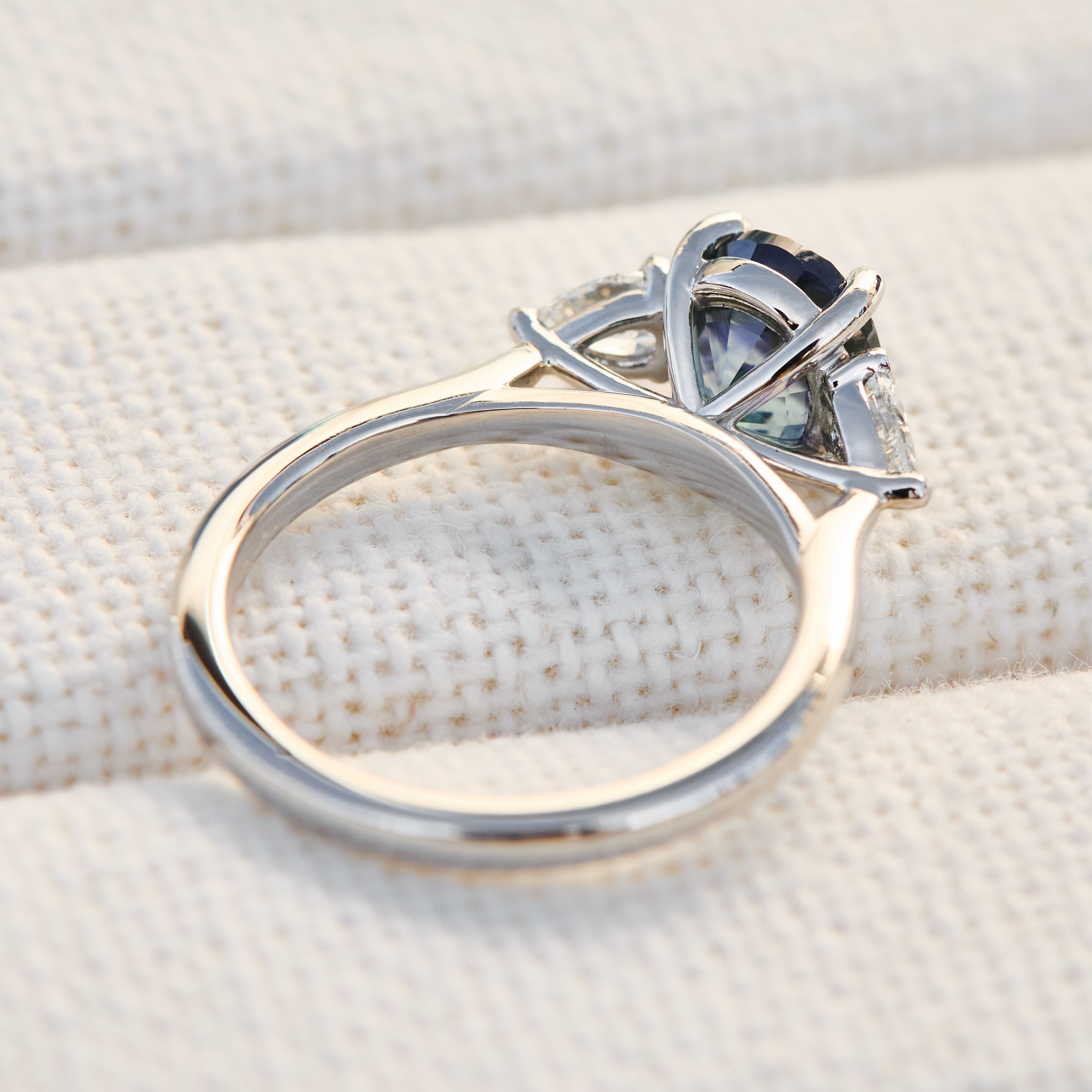 oval blue teal sapphire platinum trilogy engagement ring