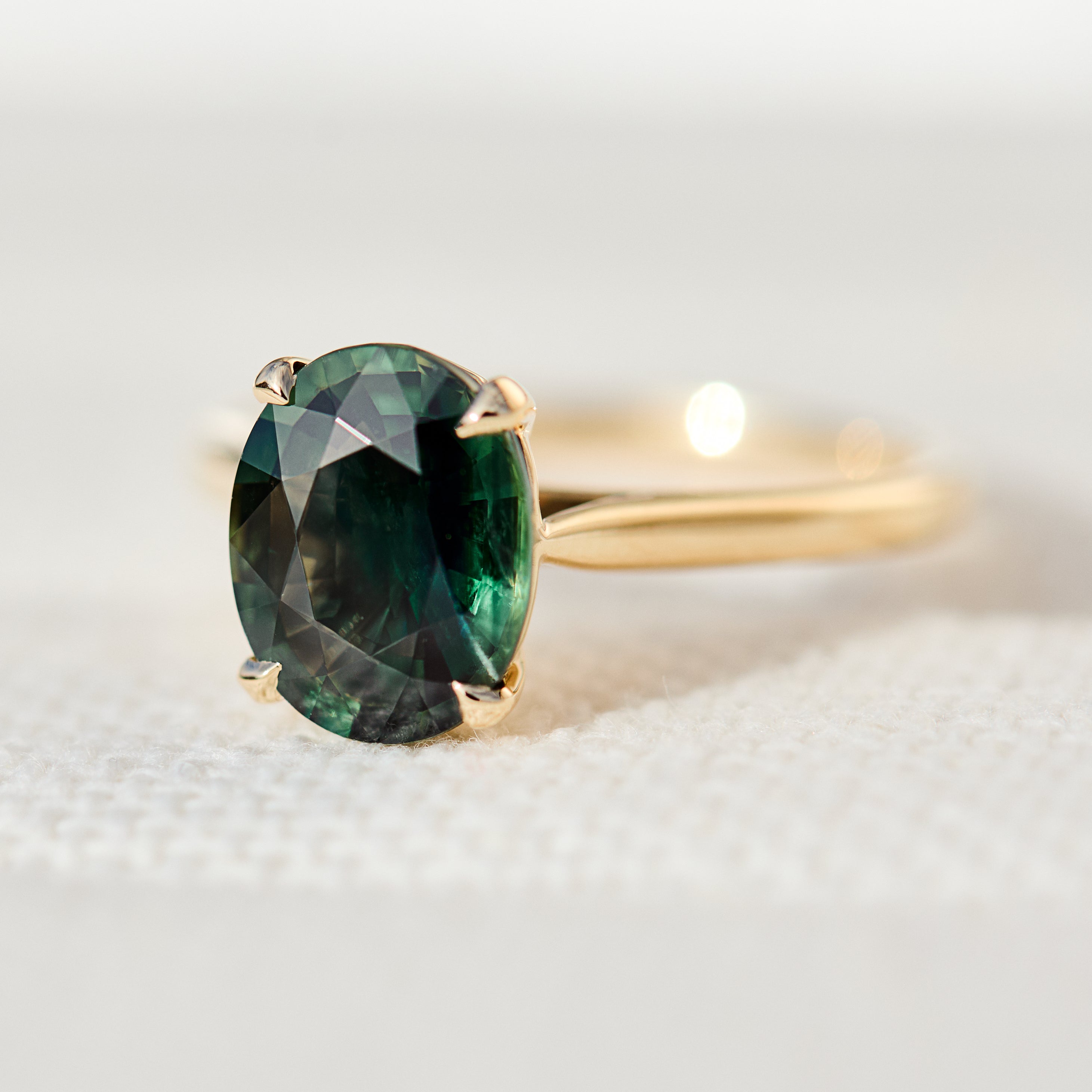 oval teal sapphire solitaire ring