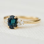 oval teal sapphire yellow gold engagement ring