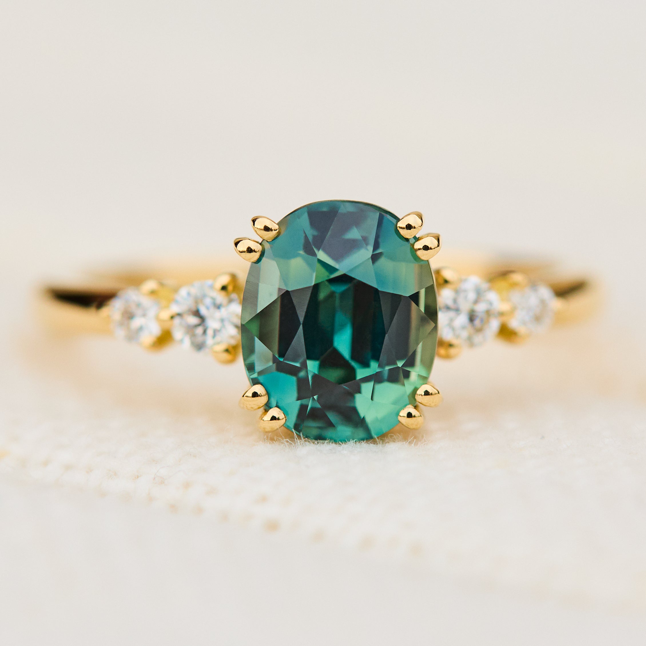 oval teal sapphire yellow gold engagement ring uk