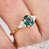 oval unheated green teal sapphire engagement ring in yellow gold
