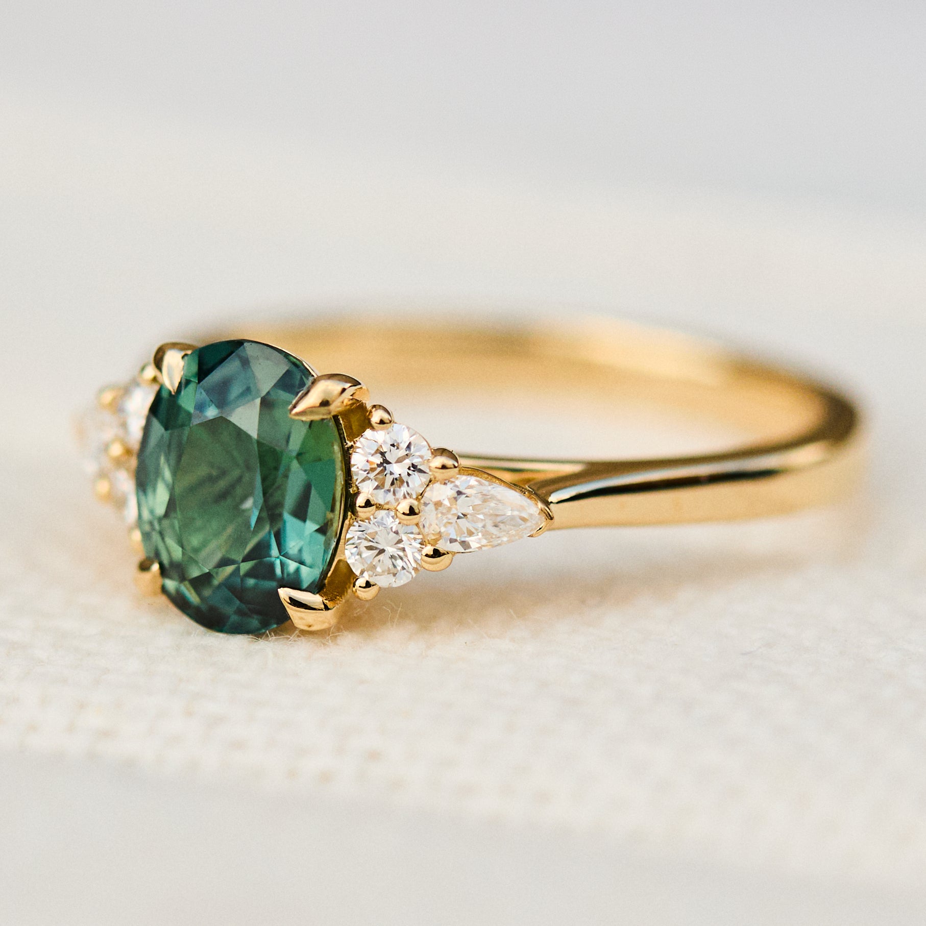 oval unheated green teal sapphire engagement ring in yellow gold