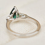pear shape green teal sapphire trilogy engagement ring in platinum