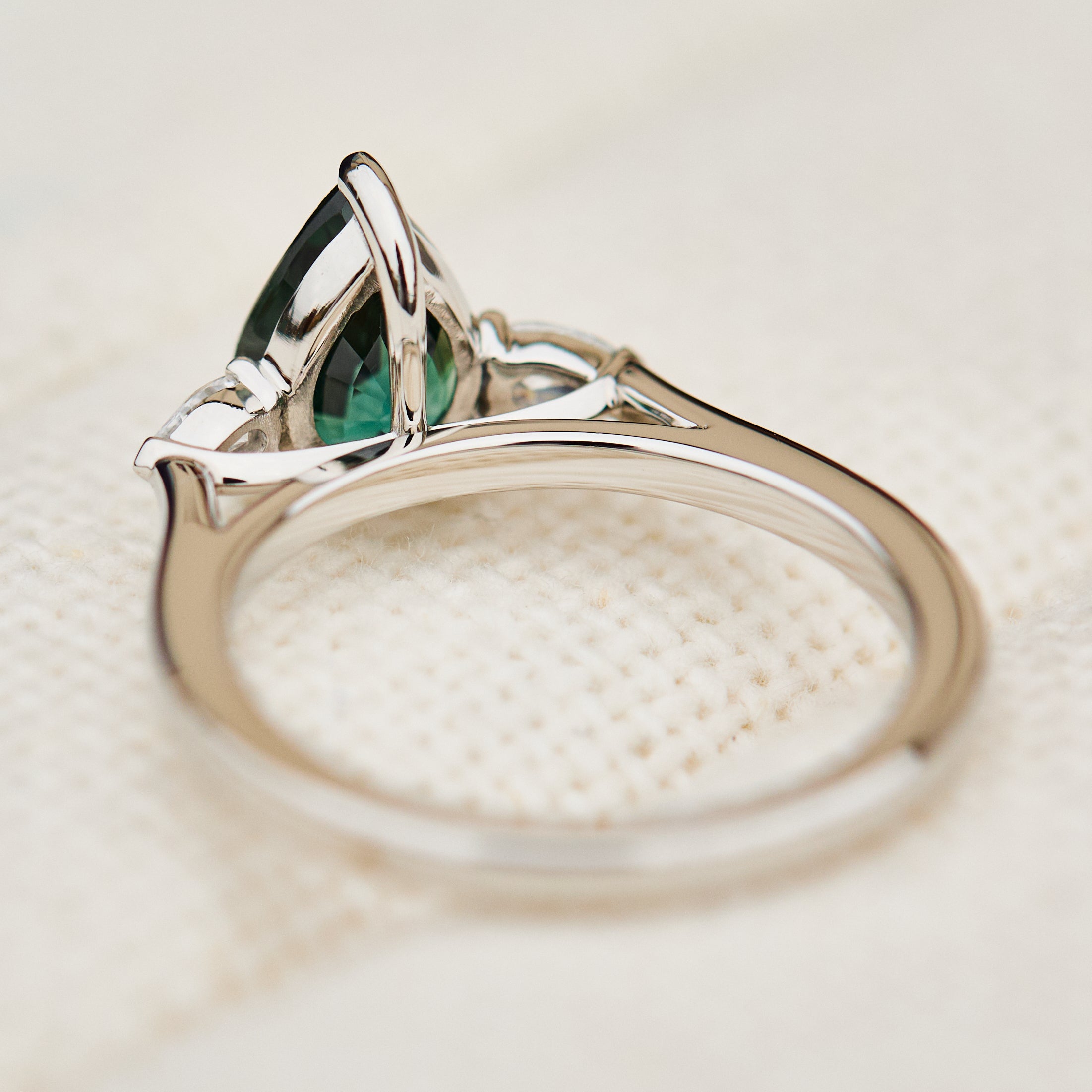 pear shape green teal sapphire trilogy engagement ring in platinum