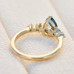 pear shape blue teal sapphire engagement ring set in yellow gold