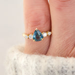 pear shape blue teal sapphire engagement ring set in yellow gold