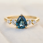 pear shape blue teal sapphire engagement ring set in yellow gold
