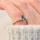 pear shape blue teal sapphire engagement ring set in yellow gold