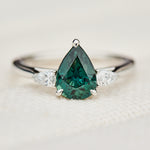 pear shape green teal sapphire trilogy engagement ring in platinum