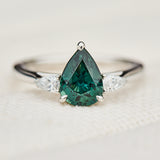 pear shape green teal sapphire trilogy engagement ring in platinum