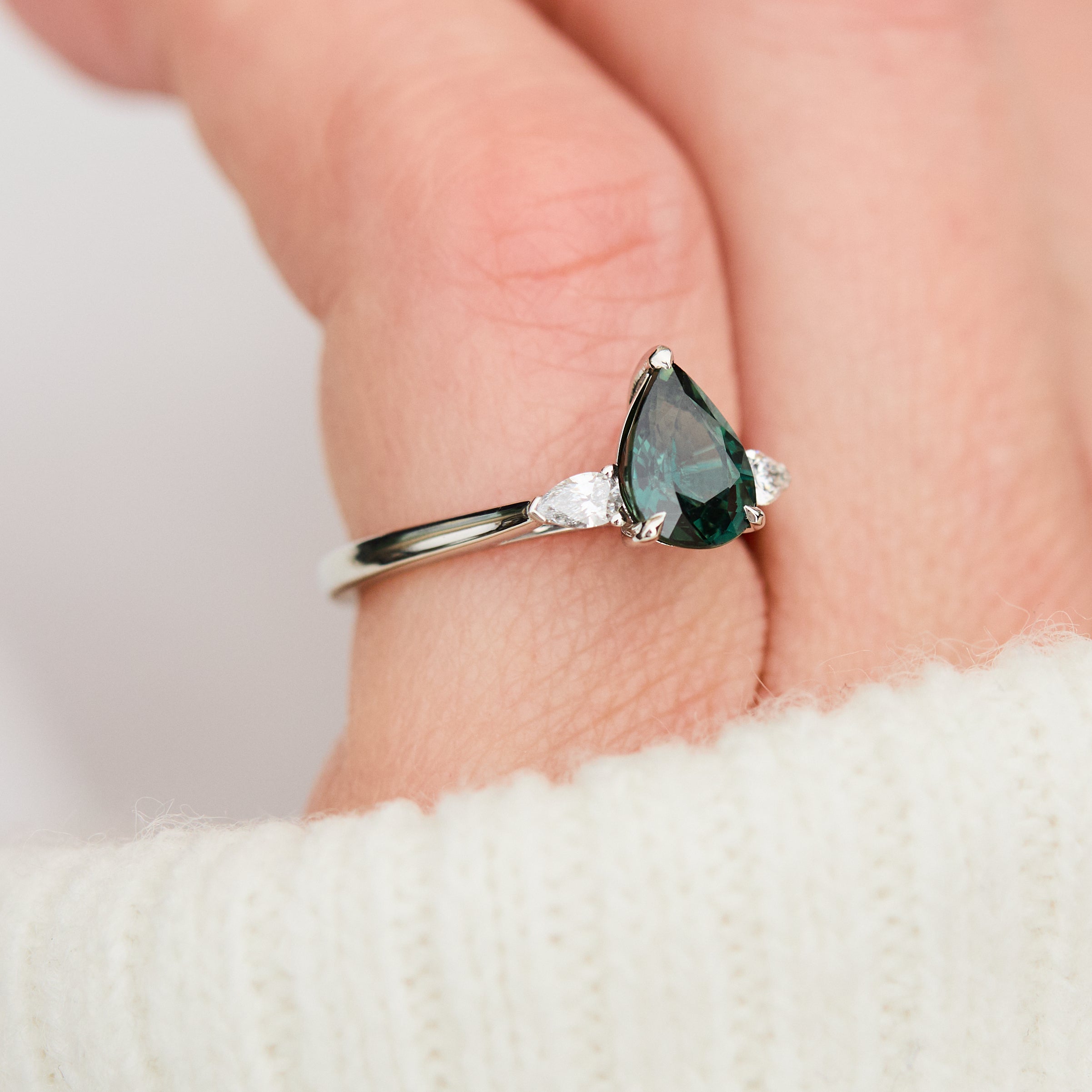 pear shape green teal sapphire trilogy engagement ring in platinum