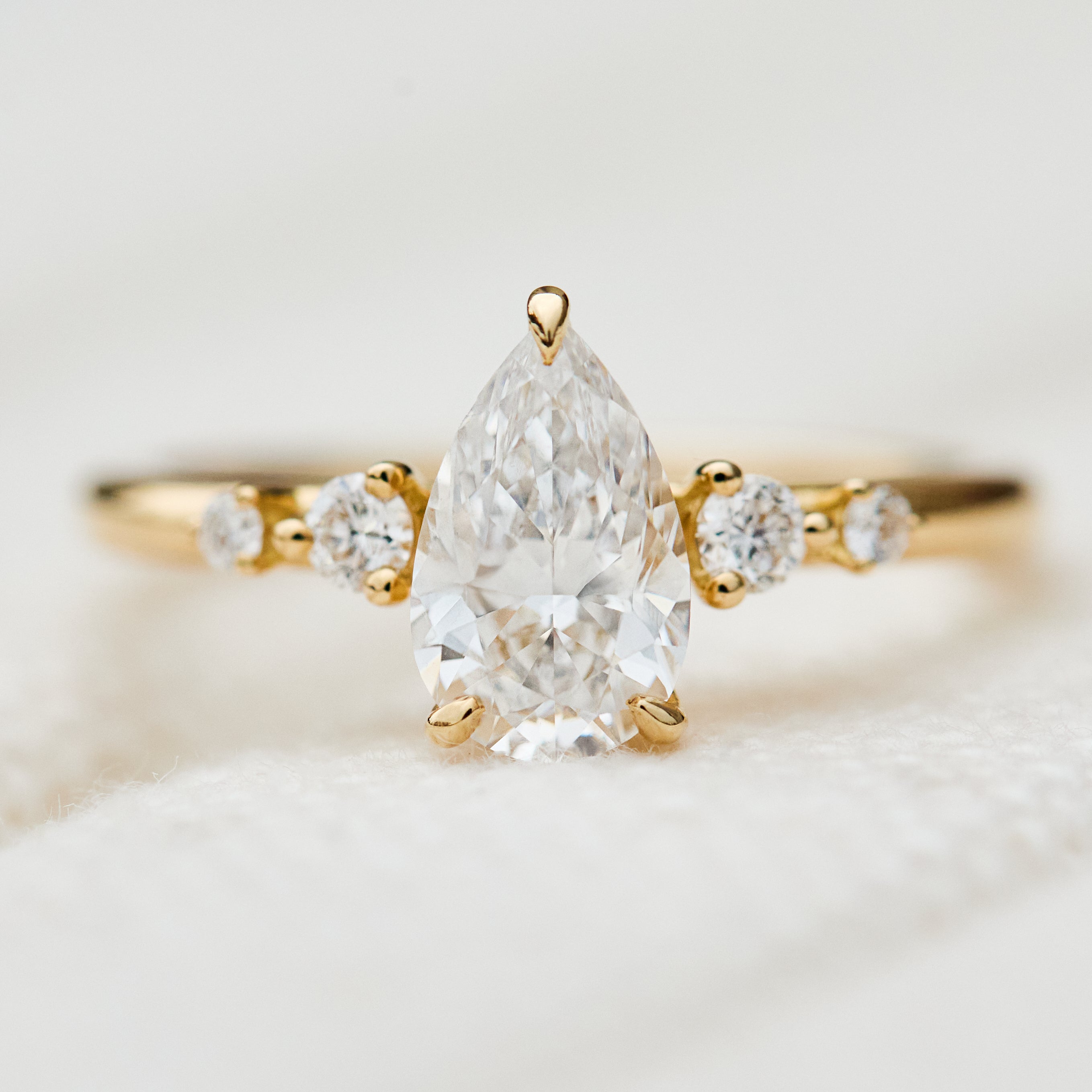 pear shape lab grown diamond engagement ring in yellow gold
