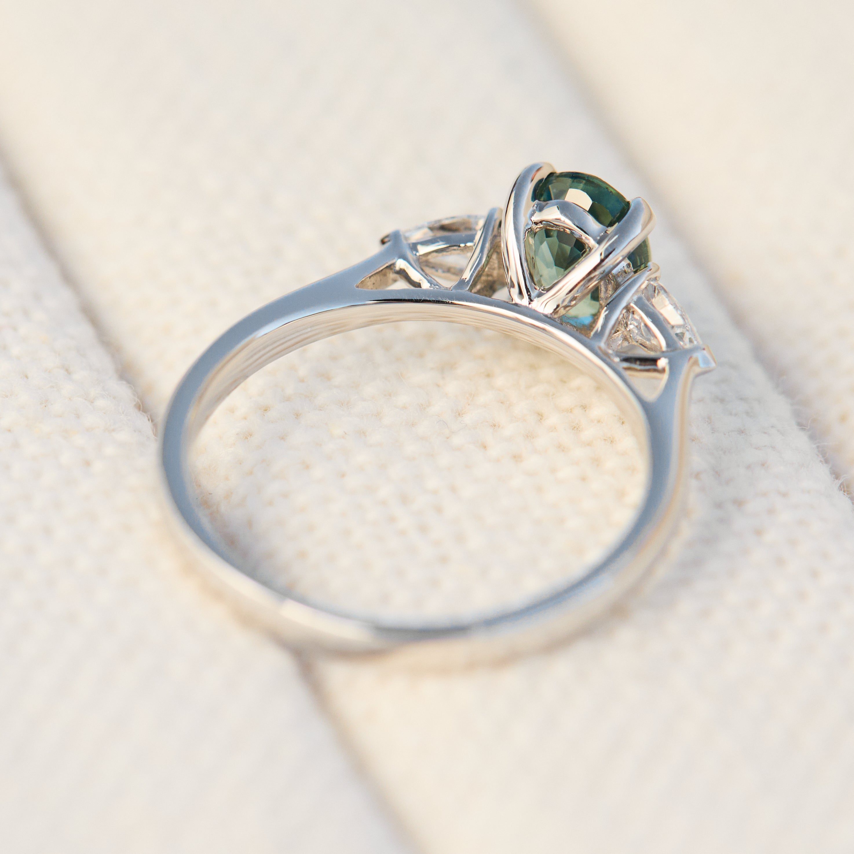 platinum oval teal sapphire engagement trilogy ring