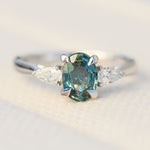 platinum oval teal sapphire engagement trilogy ring