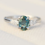platinum oval teal sapphire engagement trilogy ring