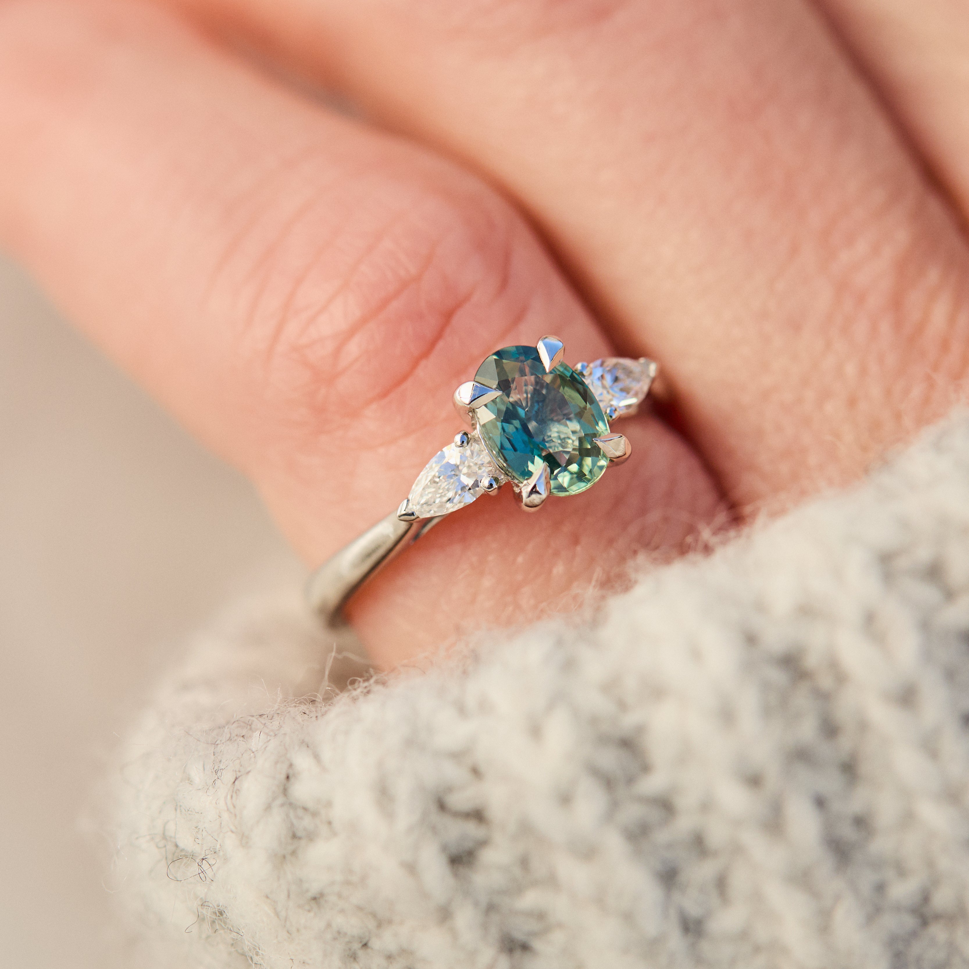 platinum oval teal sapphire engagement trilogy ring