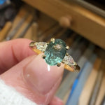 oval blue teal montana sapphire engagement ring in yellow gold