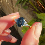 australian oval teal sapphire engagement ring with round diamond side stones