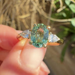 oval green sapphire engagement ring yellow gold