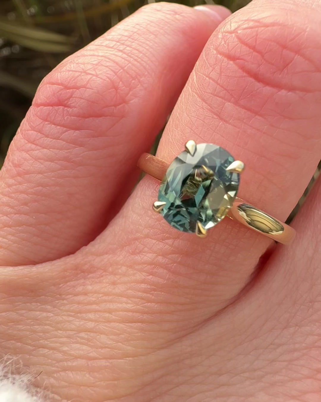oval teal sapphire solitaire engagement ring in yellow gold