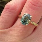 oval teal sapphire solitaire engagement ring in yellow gold