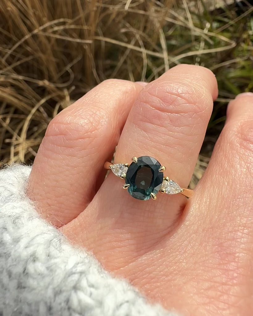 oval australian teal sapphire trilogy engagement ring in yellow gold