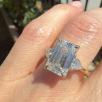 emerald cut lab grown diamond trilogy engagement ring set in yellow gold