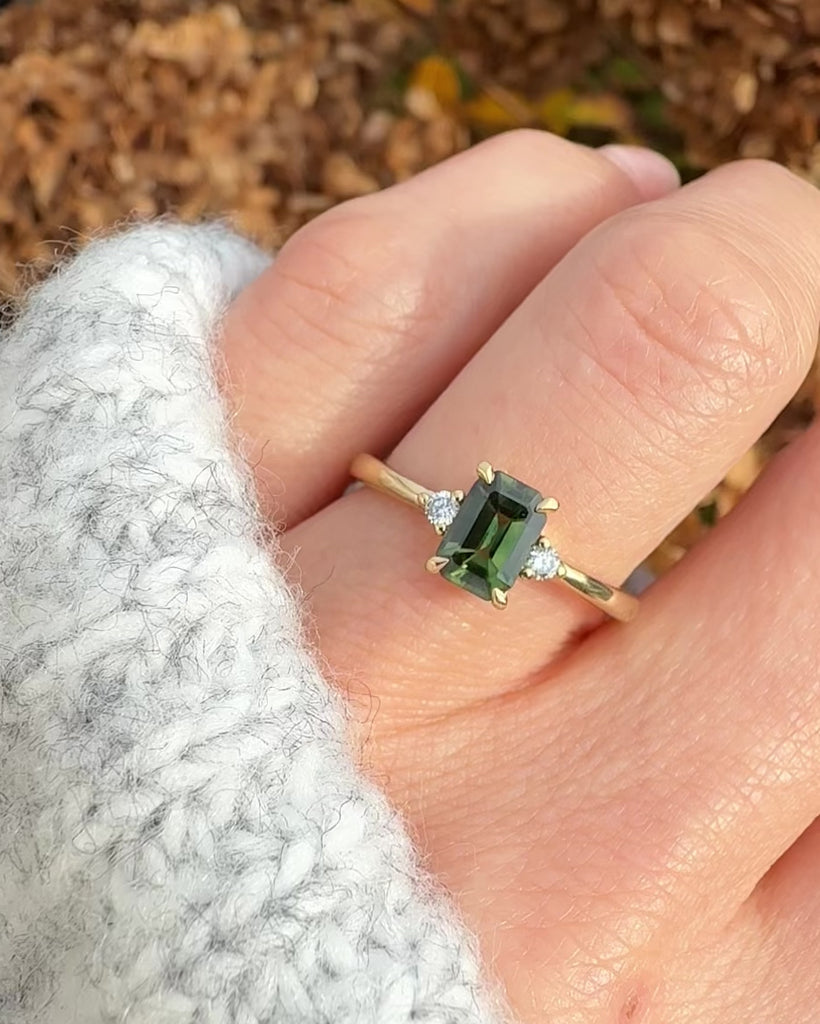 emerald cut green sapphire ring in yellow gold